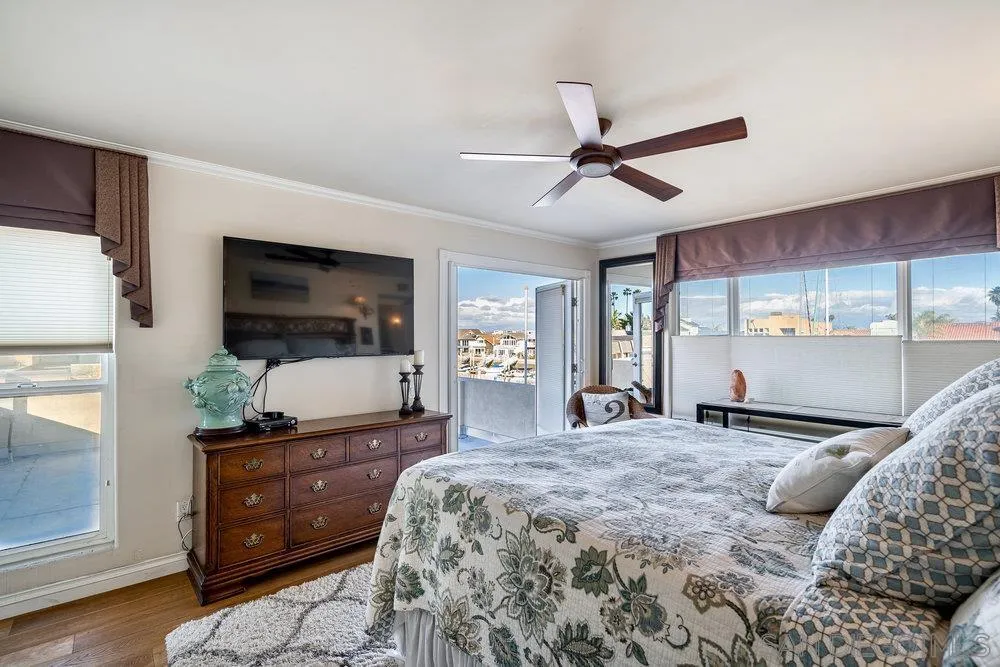 4 GingerTree Lane Coronado, CA 92118 - Photo 24 of 54 a bedroom with a bed and large windows
