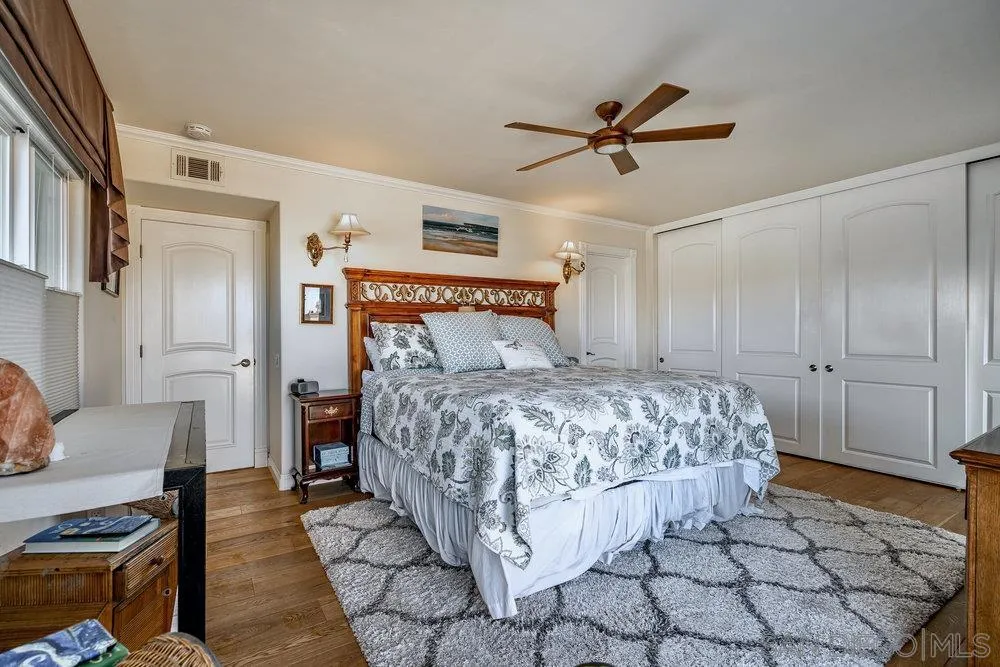 4 GingerTree Lane Coronado, CA 92118 - Photo 25 of 54 a bedroom with a bed and a chandelier