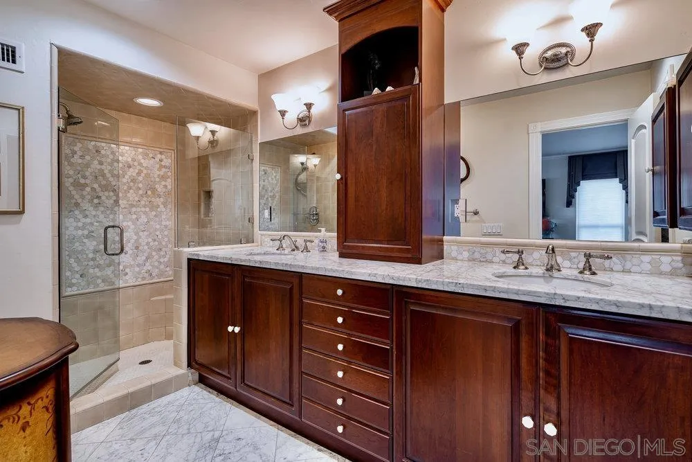 4 GingerTree Lane Coronado, CA 92118 - Photo 26 of 54 a bathroom with a granite countertop double vanity sink mirror and shower