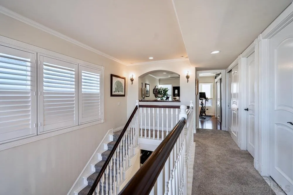 4 GingerTree Lane Coronado, CA 92118 - Photo 31 of 54 a view of a hallway with wooden floor and stairs