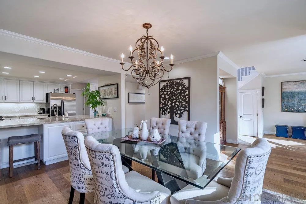 4 GingerTree Lane Coronado, CA 92118 - Photo 7 of 54 a view of a dining room with furniture a chandelier and wooden floor