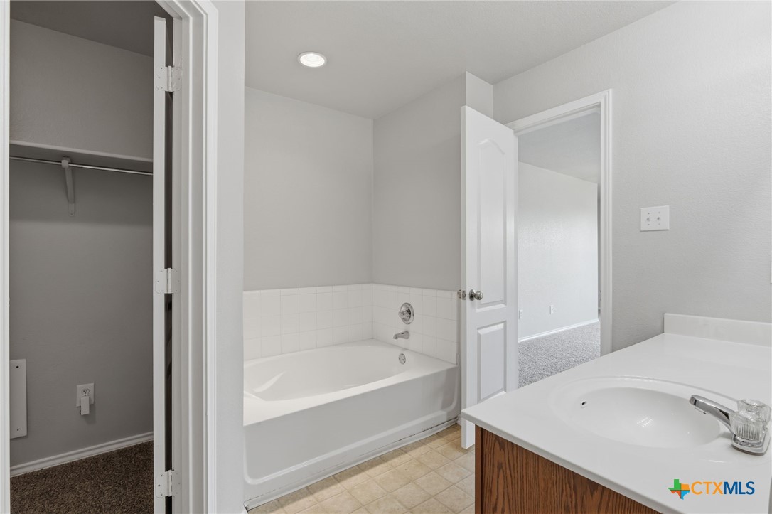 8716 Starview Street Temple, TX 76502 - Photo 19 of 36 Primary full bathroom with a standard tub/shower combo and natural light.