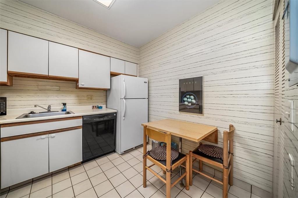 5715 Beacon Street, Unit 108 Pittsburgh, PA 15217 - Photo 11 of 27 a kitchen with a sink a refrigerator and cabinets