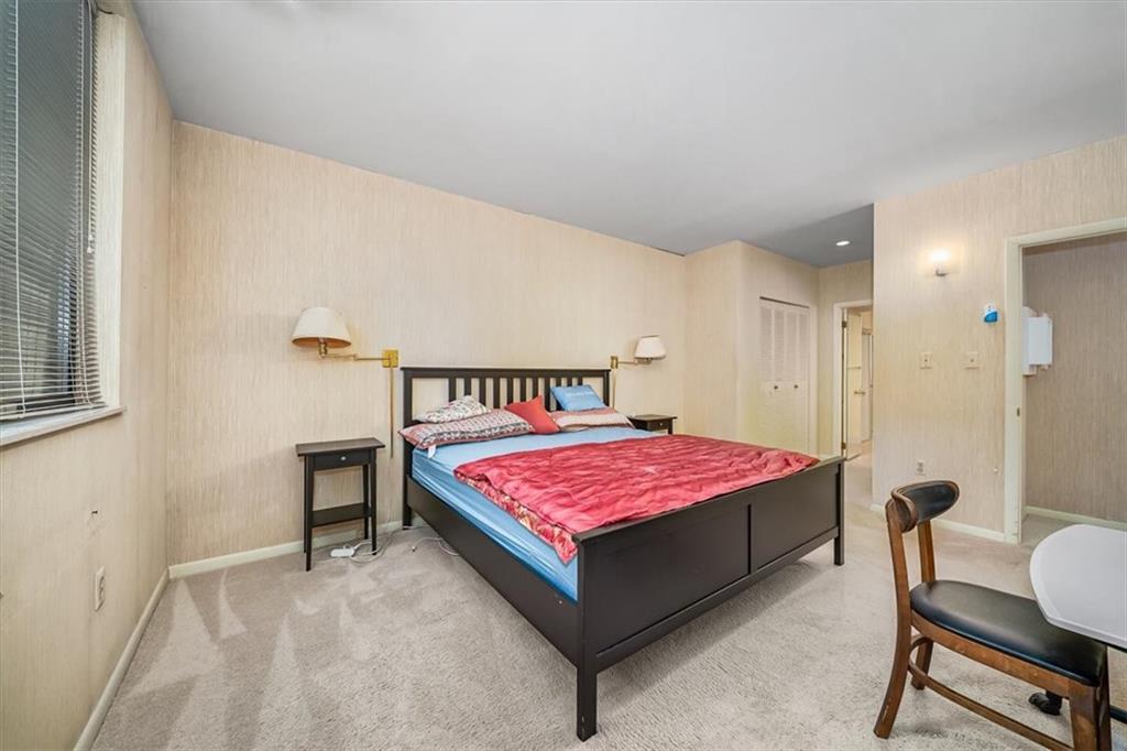 5715 Beacon Street, Unit 108 Pittsburgh, PA 15217 - Photo 14 of 27 a bedroom with a bed a table and chair