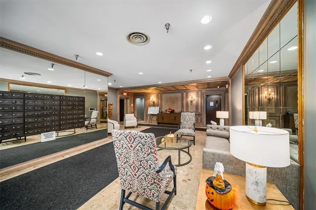 a living room with fireplace furniture and a floor to ceiling window