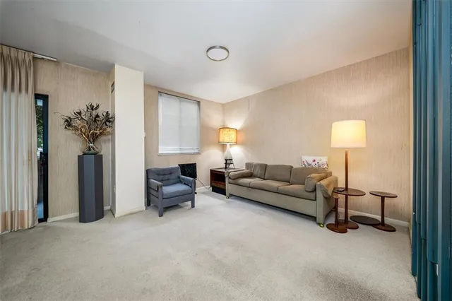 a living room with furniture and a lamp