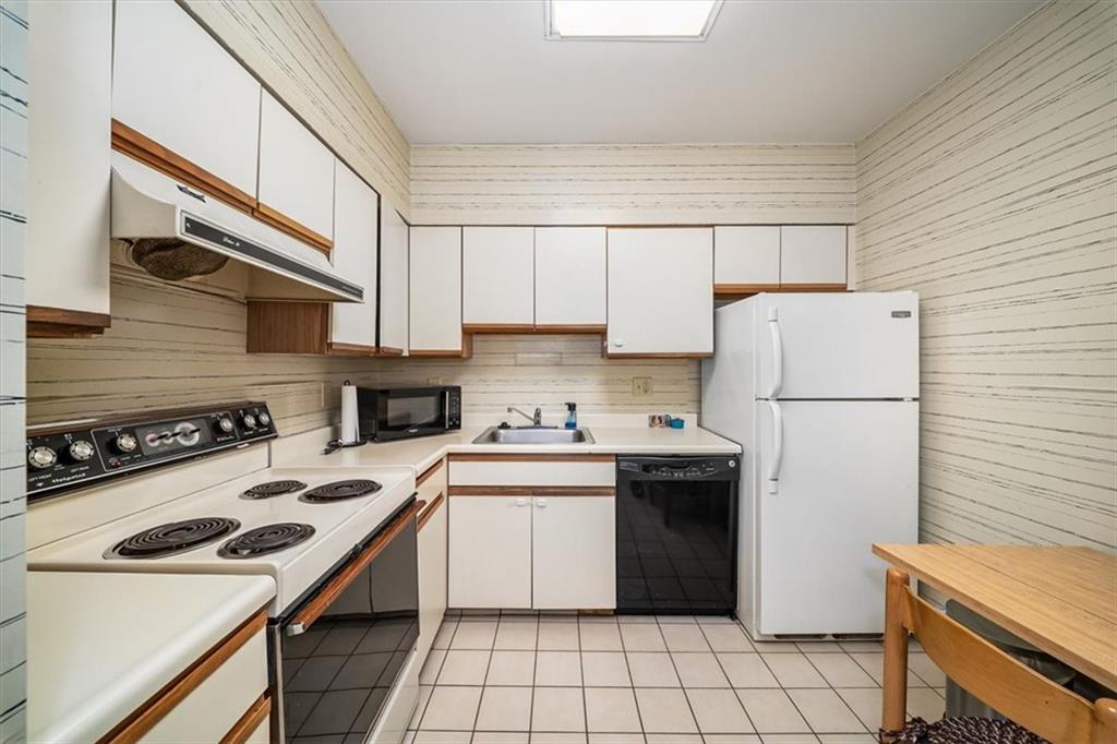5715 Beacon Street, Unit 108 Pittsburgh, PA 15217 - Photo 10 of 27 a kitchen with a sink a stove and white cabinets