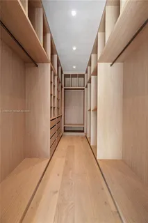 a bathroom with a sink and mirror with bathtub