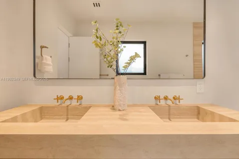 a bathroom with a toilet a sink a shower and mirror