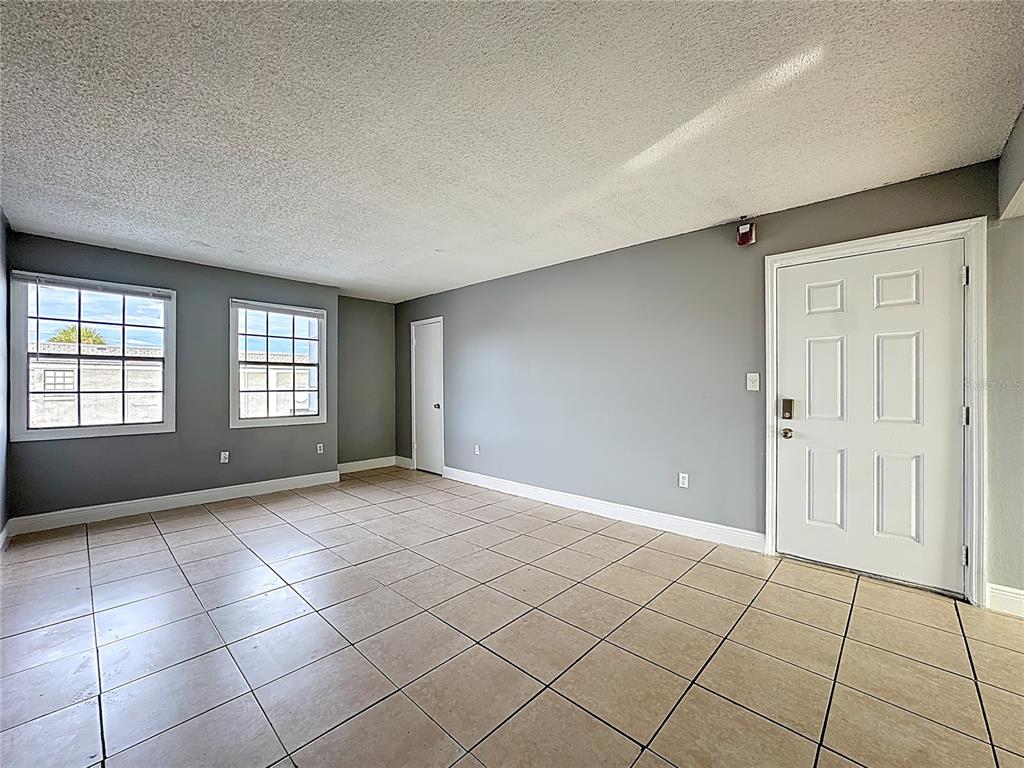 2753 L B McLeod Road, Unit D Orlando, FL 32805 - Photo 7 of 48 a view of an empty room with window and chandelier