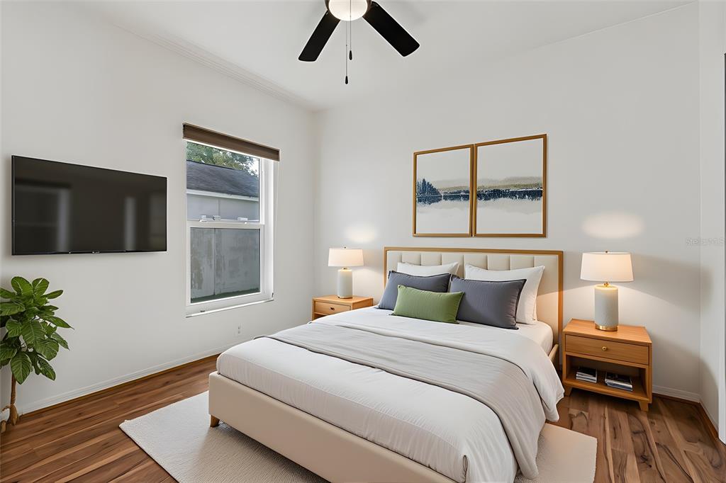 5311 Watson Road Riverview, FL 33578 - Photo 21 of 33 a bedroom with a bed and a potted plant