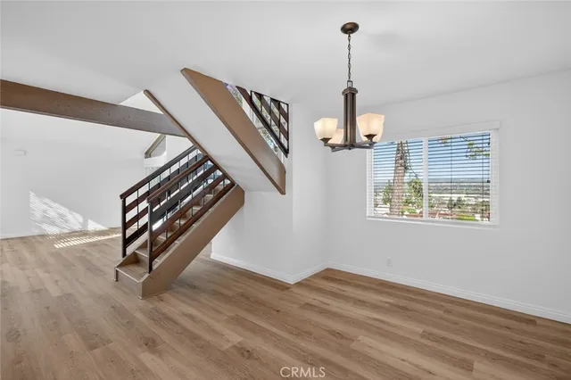 a view of a room with a window and wooden floor