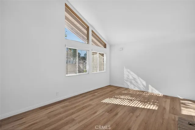 a living room with stainless steel appliances granite countertop a sink and a large window