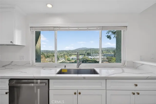 a kitchen with a sink a stove and microwave