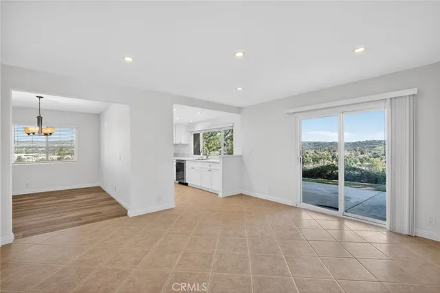 a view of an entryway with wooden floor and a fireplace