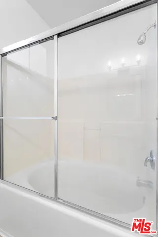 a bathroom with a shower and a glass door shower