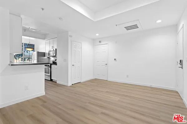 a view of a kitchen with wooden floor and a sink