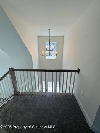a view of kitchen with kitchen island wooden floors and stainless steel appliances