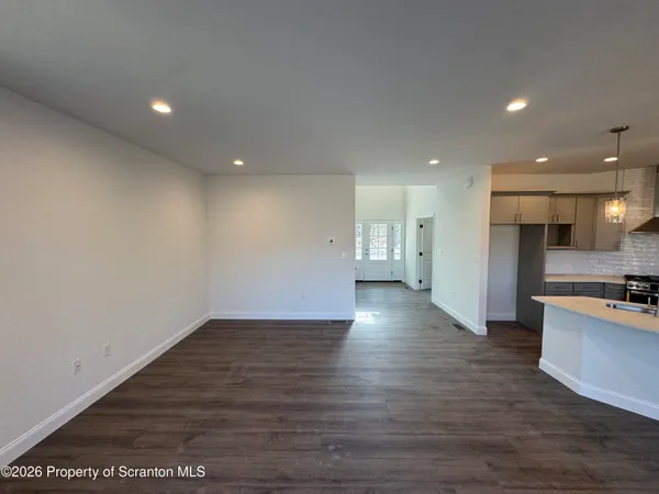 an empty room with wooden floor