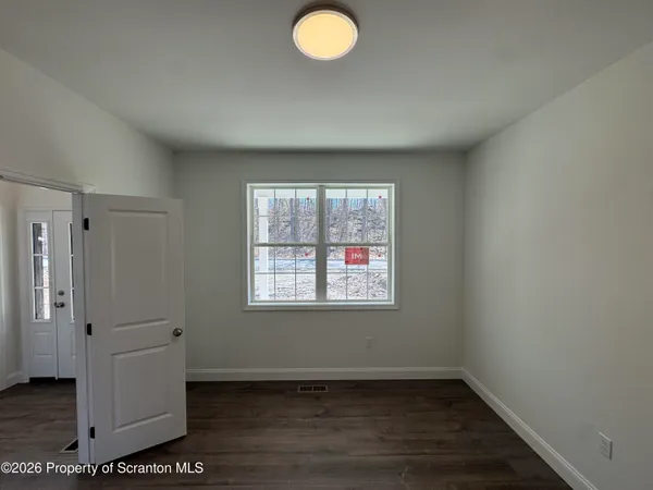 a view of a livingroom with a ceiling fan and window