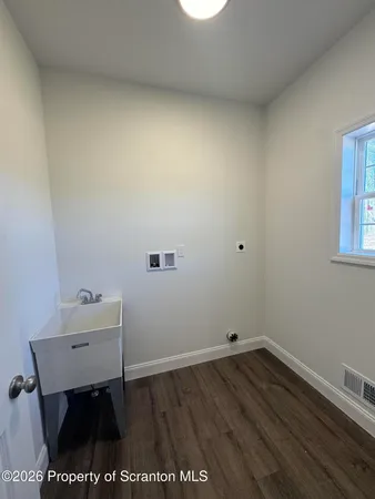 a white bath tub sitting in a bathroom next to a window