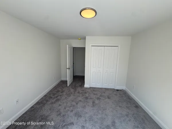 a bathroom with a shower a sink and a mirror