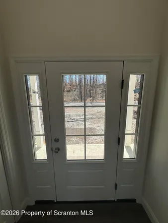 a kitchen with a refrigerator and a stove top oven
