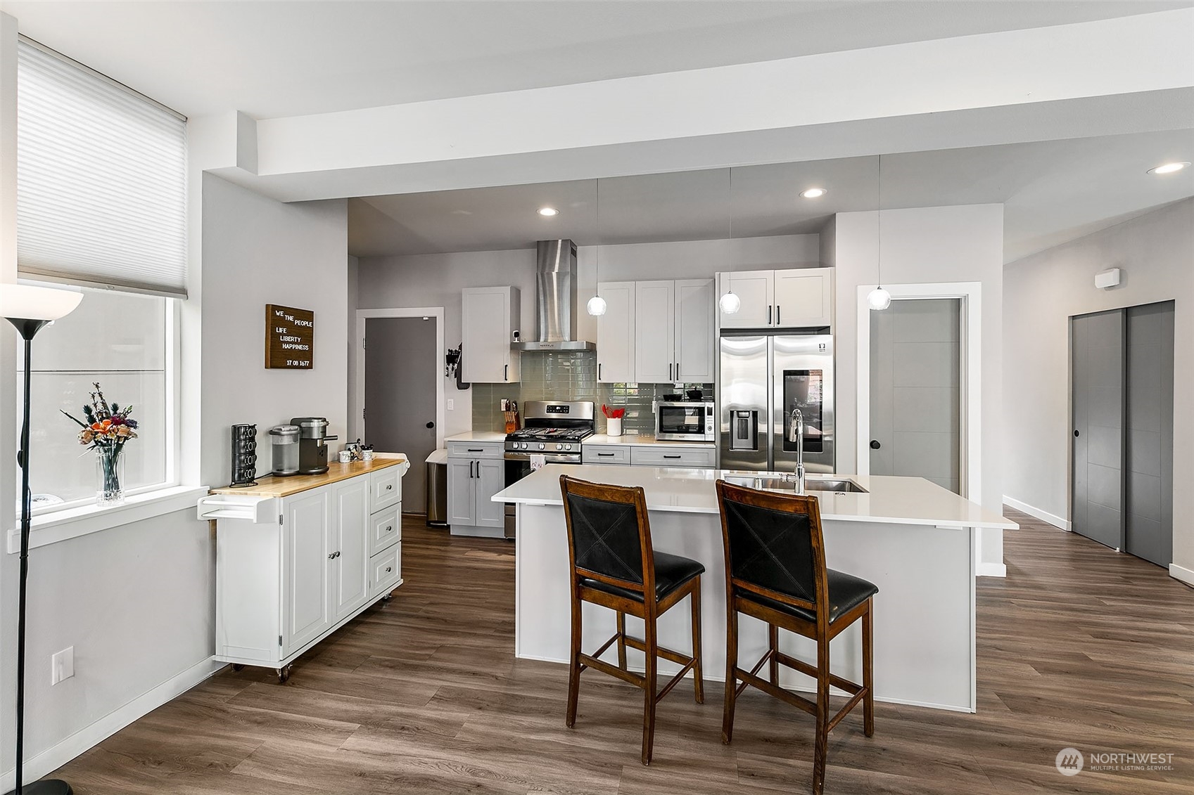 5136 South Creston Street Seattle, WA 98178 - Photo 11 of 27 a kitchen with white cabinets and stainless steel appliances