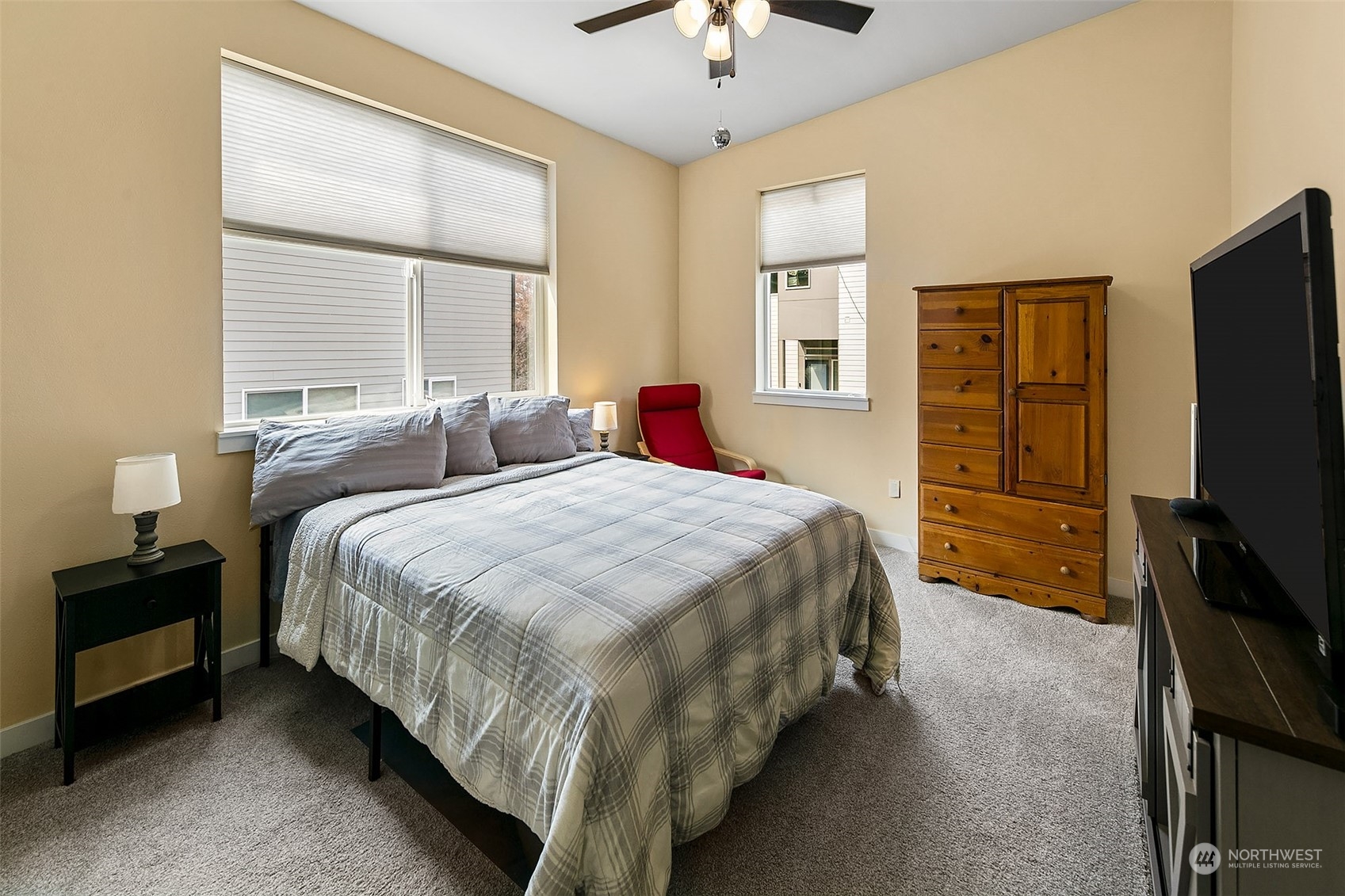 5136 South Creston Street Seattle, WA 98178 - Photo 17 of 27 a bedroom with a bed and a flat tv screen on dresser