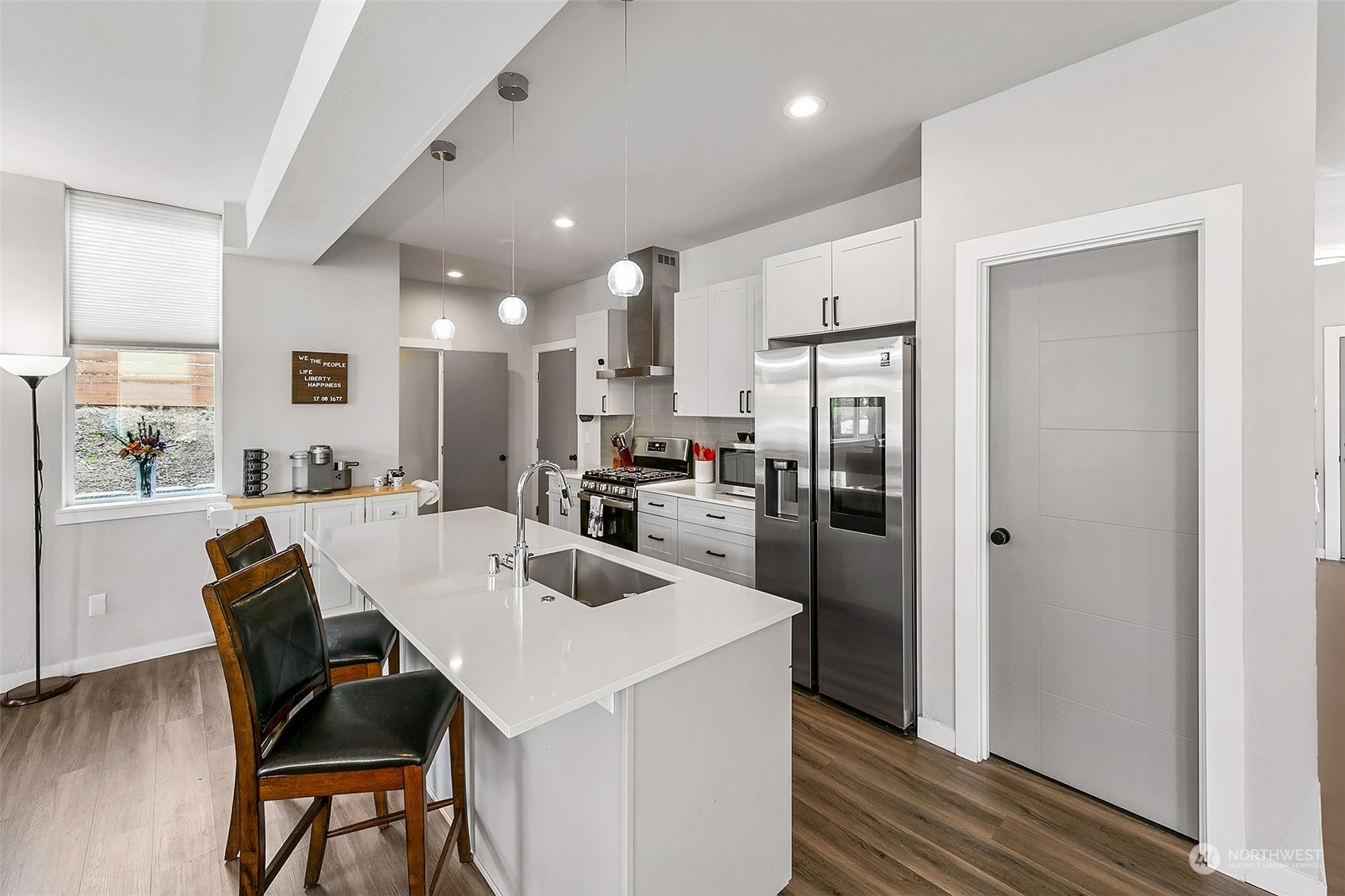 5136 South Creston Street Seattle, WA 98178 - Photo 22 of 27 a kitchen with a refrigerator a dining table and chairs