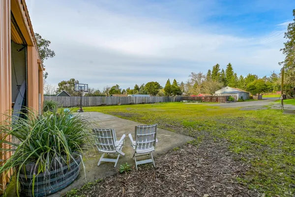 a view of a house with a yard and sitting area