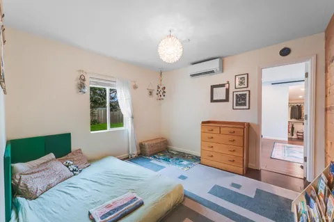 a bedroom with a bed and a window