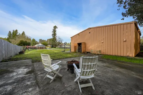 a front view of house with outdoor seating and yard