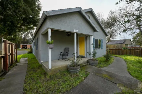 a view of a backyard with couches and plants