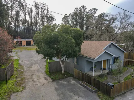 a view of house with backyard
