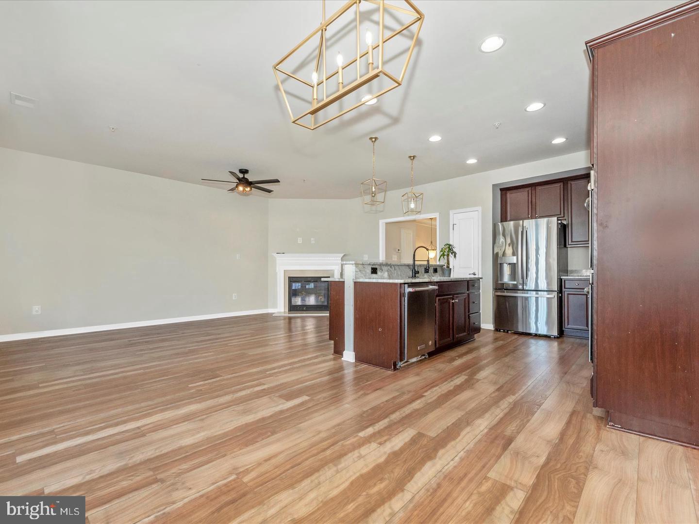 208 B Mill Pond Road Frederick, MD 21701 - Photo 16 of 45 a large kitchen with stainless steel appliances kitchen island a large counter top and wooden floors