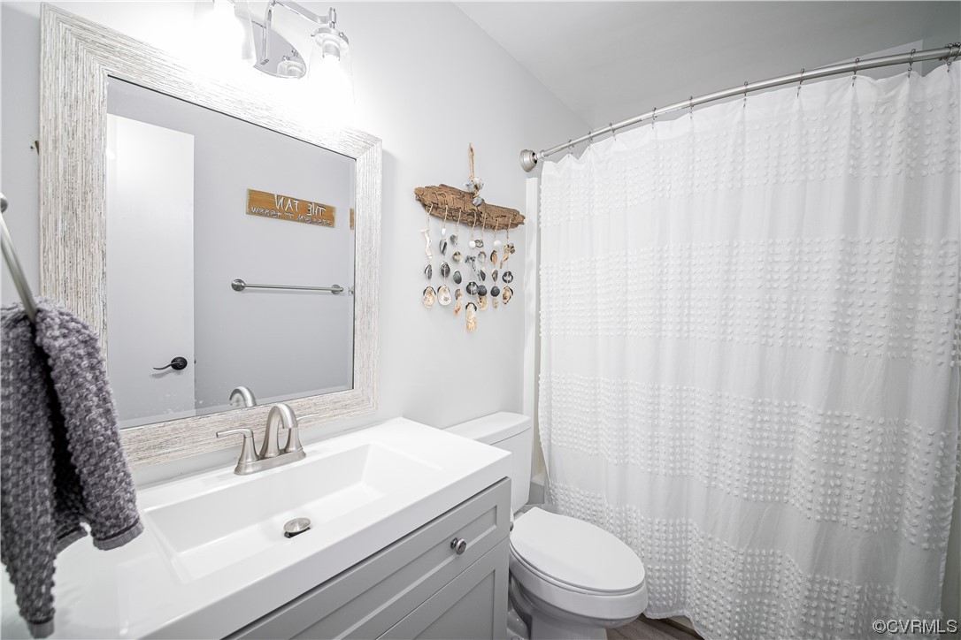 11601 East Briar Patch Drive Midlothian, VA 23113 - Photo 34 of 50 a bathroom with a sink a toilet and shower curtain