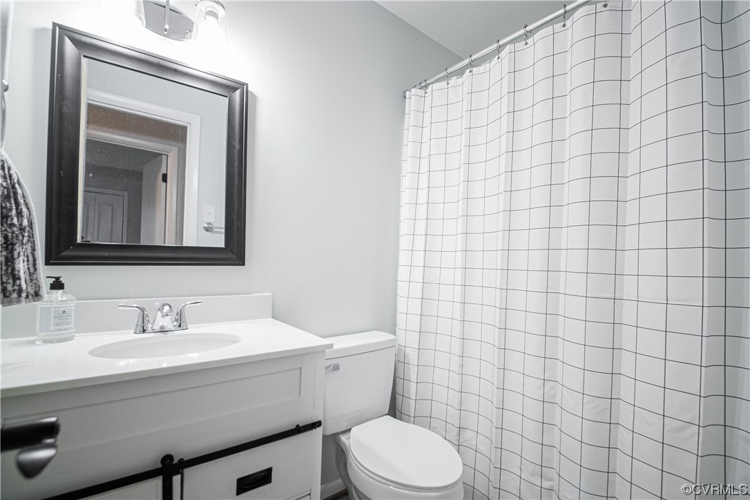 11601 East Briar Patch Drive Midlothian, VA 23113 - Photo 45 of 50 a bathroom with a toilet a sink a mirror and vanity