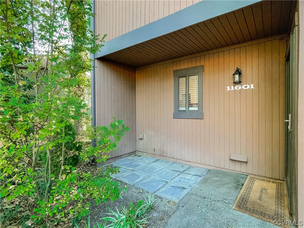 11601 East Briar Patch Drive Midlothian, VA 23113 - Photo 6 of 50 an empty room with potted plants and wooden walls