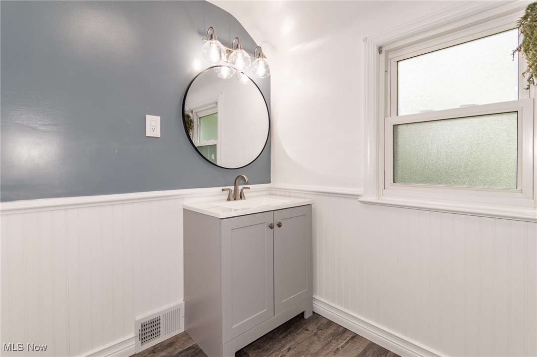 5195 Mayview Road Cleveland, OH 44124 - Photo 21 of 49 Bathroom with vanity, a wainscoted wall, and wood finished floors