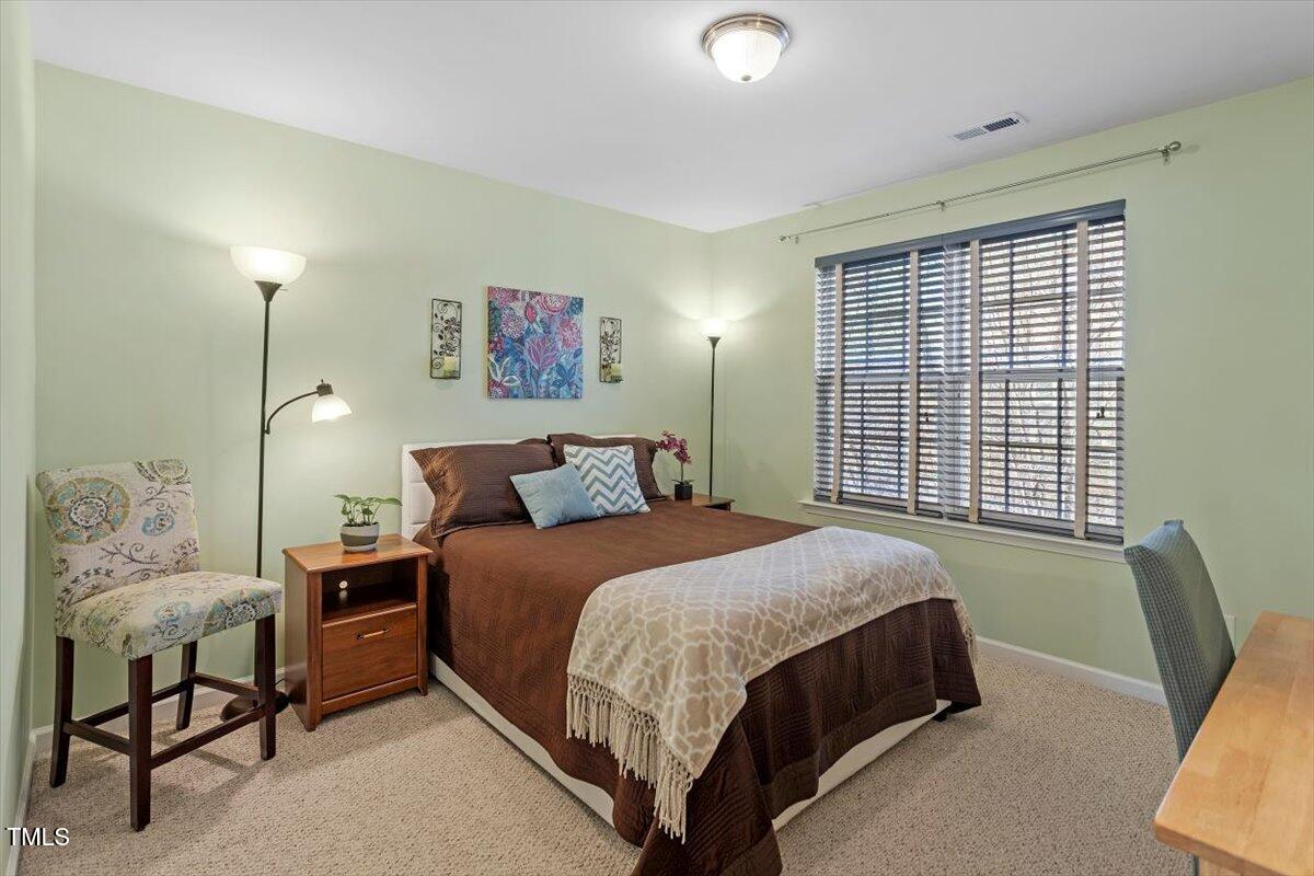 7759 Winners Edge Street Raleigh, NC 27617 - Photo 22 of 31 a bedroom with a bed and a couch