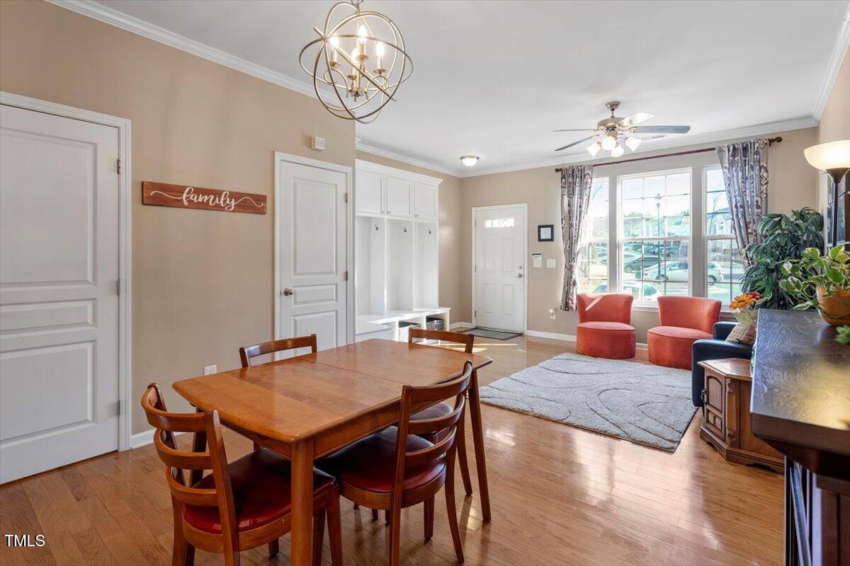 7759 Winners Edge Street Raleigh, NC 27617 - Photo 8 of 31 a view of a dining room with furniture window and wooden floor
