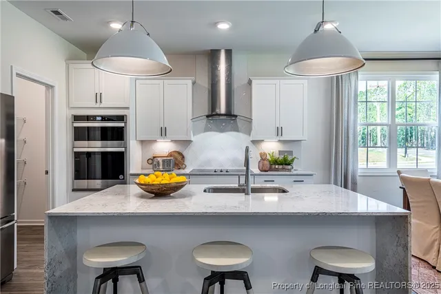 a kitchen with stainless steel appliances a sink and a table