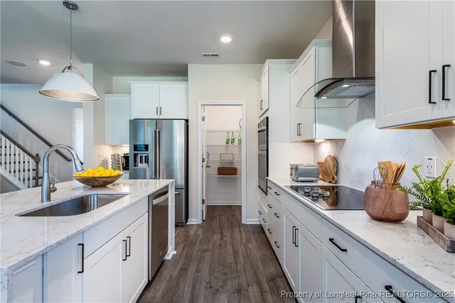 a kitchen with a sink a stove and refrigerator