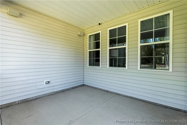 a view of a field of grass and trees