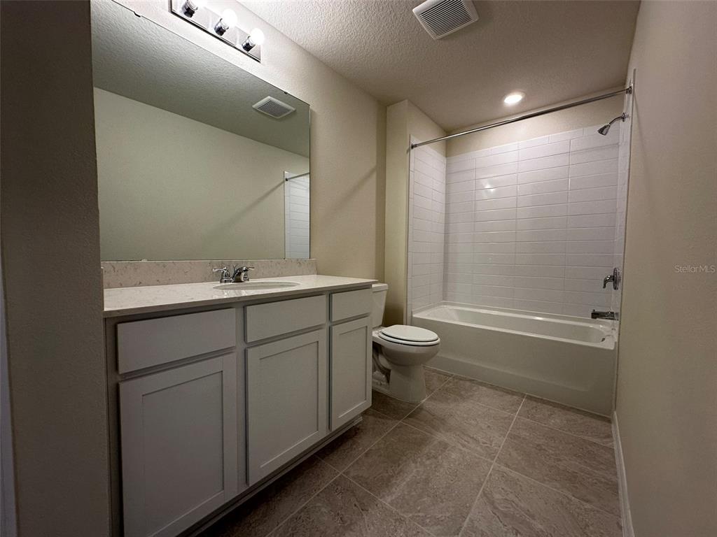 4806 Sparkling Shell Avenue Kissimmee, FL 34746 - Photo 13 of 19 a bathroom with a sink a toilet and shower