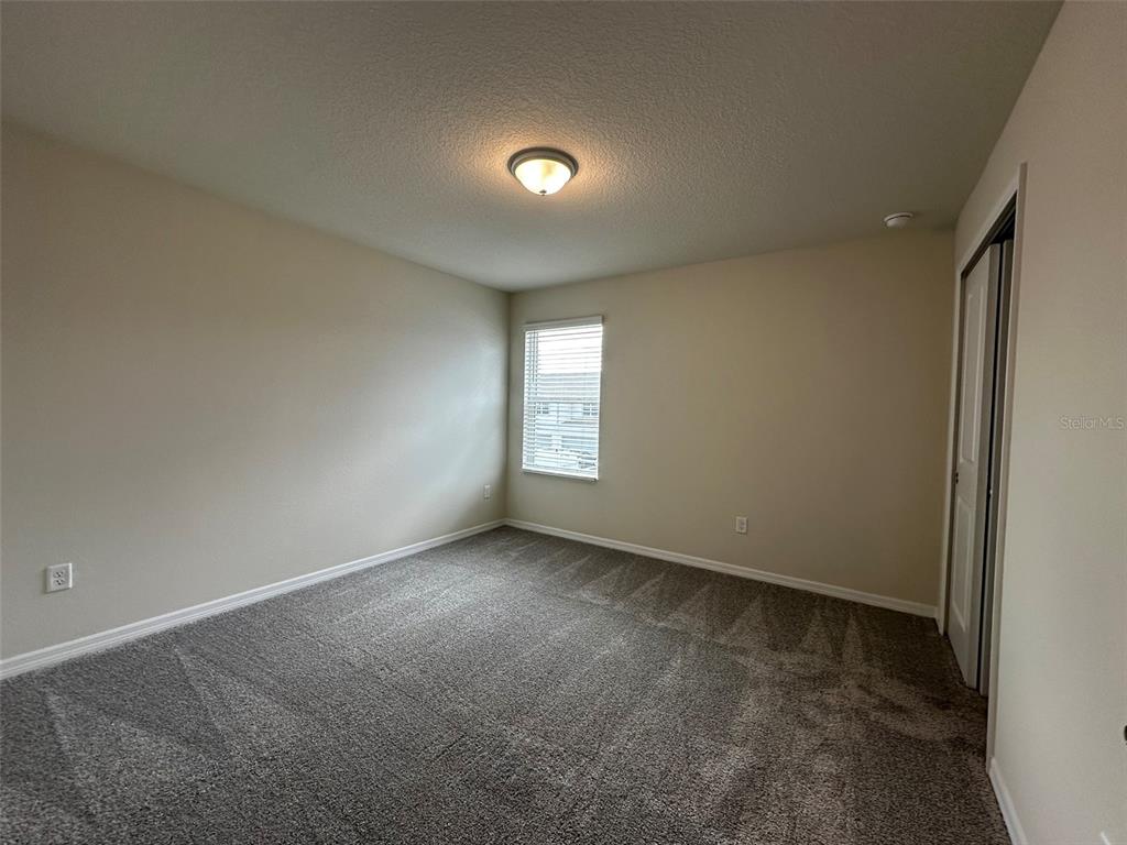 4806 Sparkling Shell Avenue Kissimmee, FL 34746 - Photo 14 of 19 a view of an empty room with a window