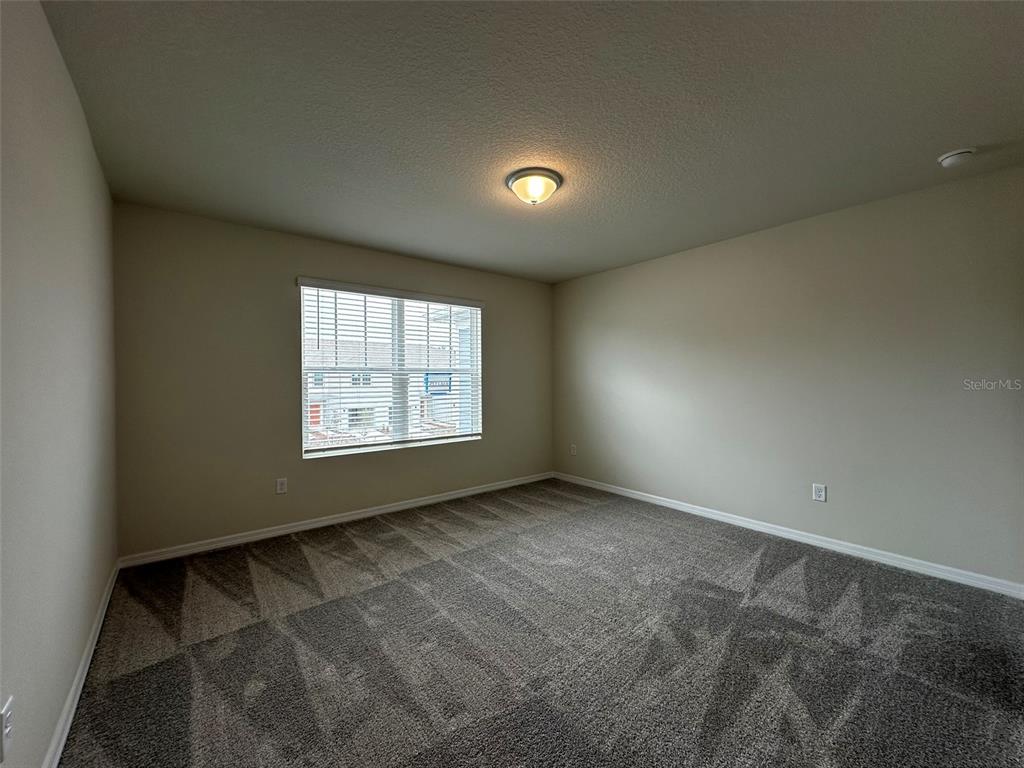 4806 Sparkling Shell Avenue Kissimmee, FL 34746 - Photo 15 of 19 an empty room with windows