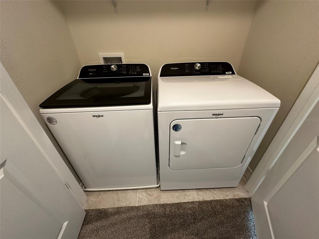 4806 Sparkling Shell Avenue Kissimmee, FL 34746 - Photo 17 of 19 a utility room with dryer and washer