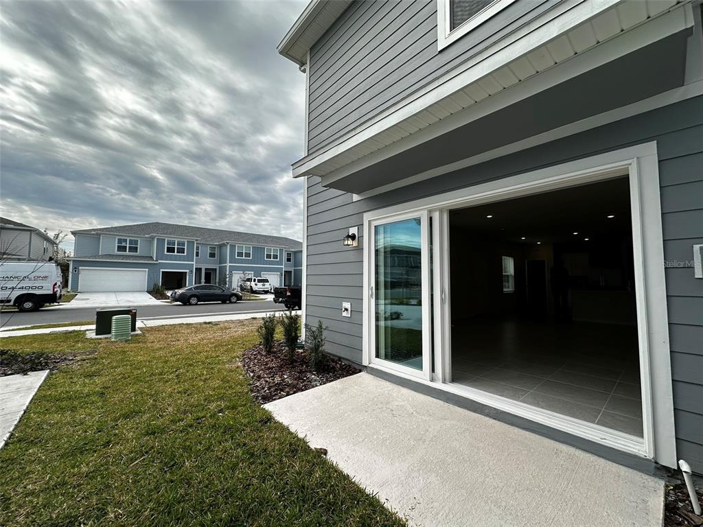 4806 Sparkling Shell Avenue Kissimmee, FL 34746 - Photo 19 of 19 a view of a house with backyard porch and sitting area